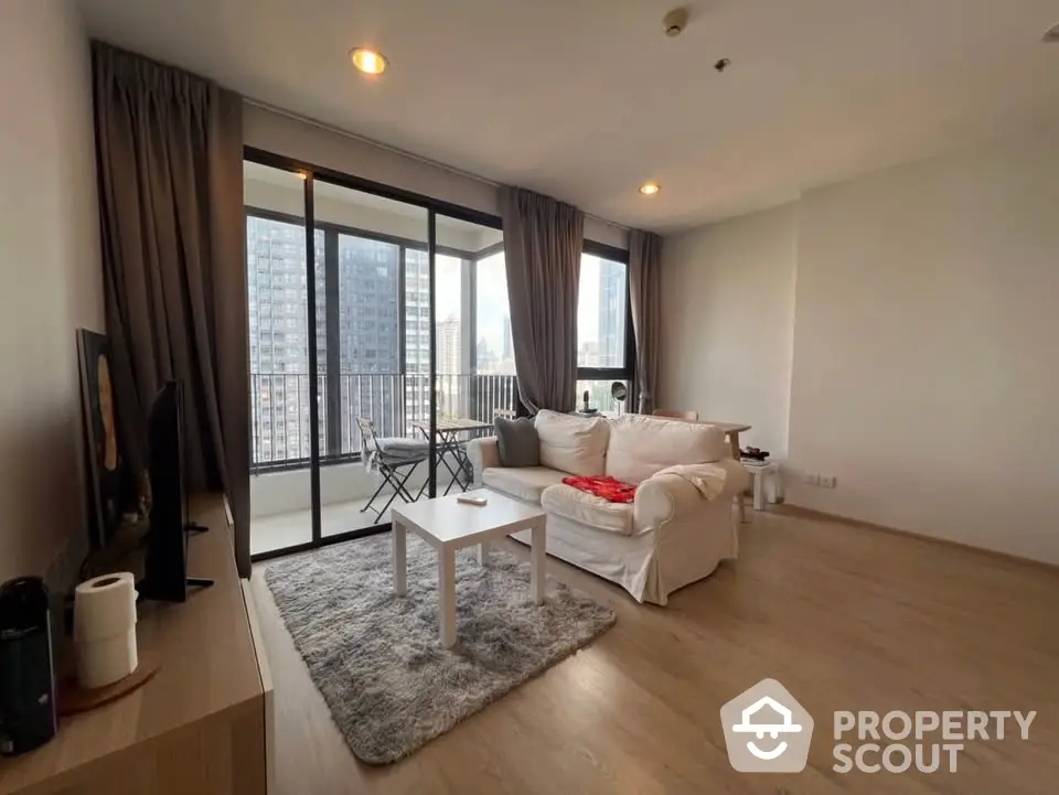 Modern living room with balcony view in high-rise apartment