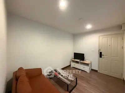 Cozy living room with modern furniture and warm lighting, perfect for relaxation.