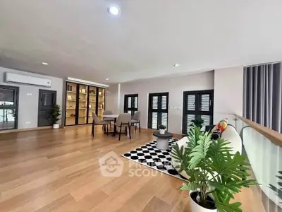 Spacious modern living room with wooden flooring and stylish decor