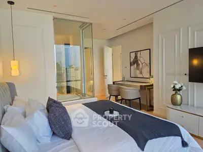 Luxurious bedroom with city view, modern decor, and elegant furnishings.