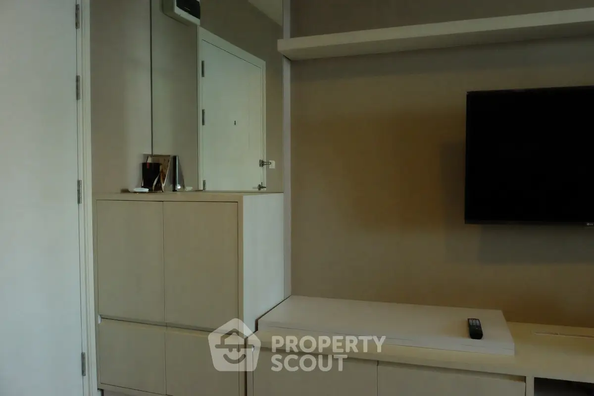 Modern living room with sleek cabinetry and wall-mounted TV