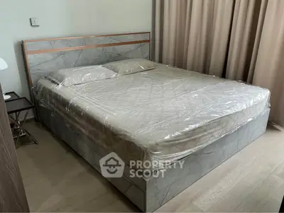 Spacious bedroom with modern bed and elegant decor, perfect for relaxation and comfort.