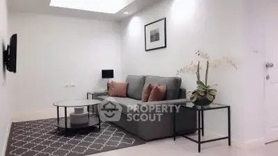 Modern living room with stylish gray sofa and elegant decor