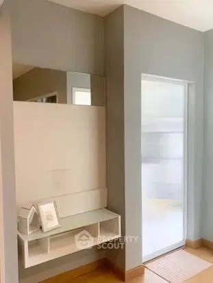 Modern minimalist hallway with sleek mirror and storage unit