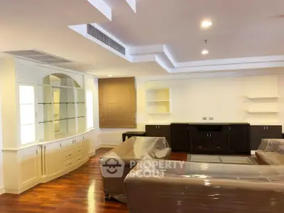 Spacious living room with elegant wooden flooring and modern furniture.