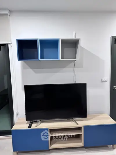 Modern living room with sleek TV stand and wall-mounted shelves