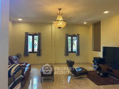 Spacious living room with elegant chandelier and modern furniture