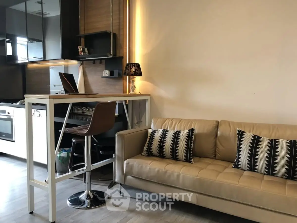 Modern living room with stylish kitchen and cozy seating area