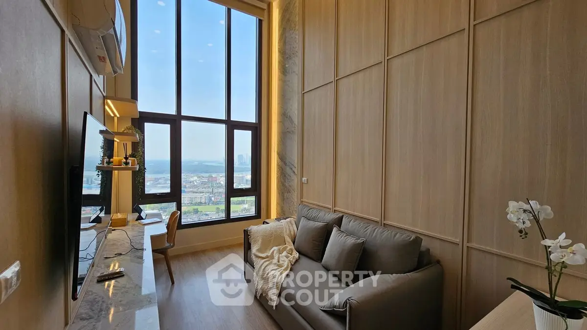 Luxurious high-ceiling living room with panoramic city view and elegant decor.