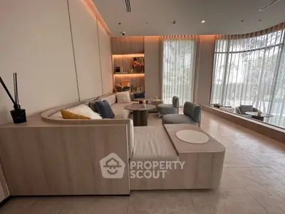 Luxurious modern living room with elegant seating and large windows offering natural light.