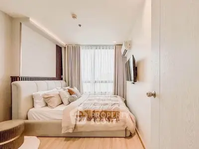 Cozy bedroom with modern decor and natural light in elegant apartment.