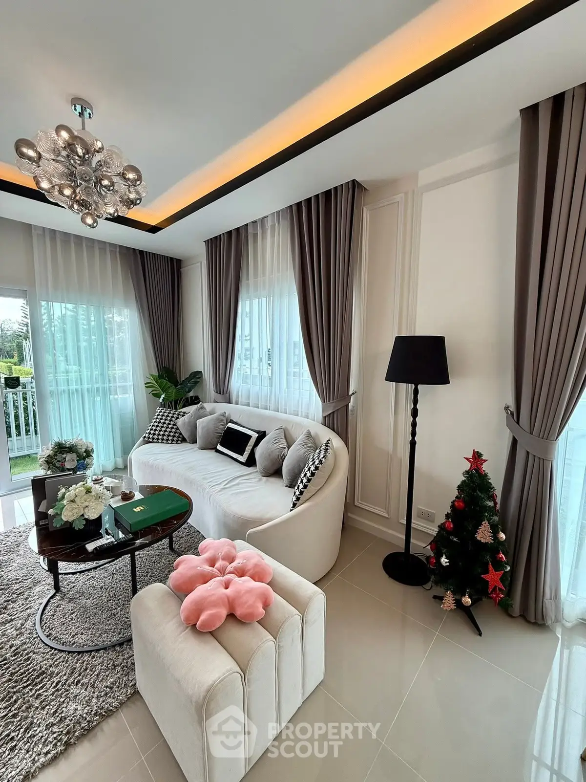 Elegant living room with modern decor and large windows offering natural light.