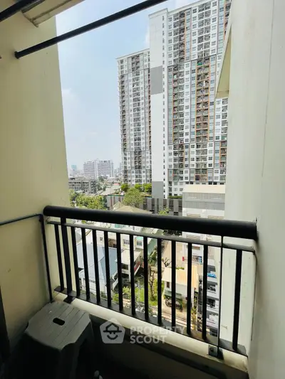 Urban balcony with cityscape view, perfect for enjoying the skyline and fresh air.