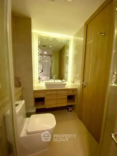 Modern bathroom with elegant lighting and sleek fixtures in a contemporary apartment.
