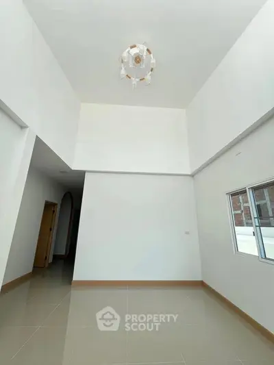 Spacious interior with high ceiling and modern chandelier