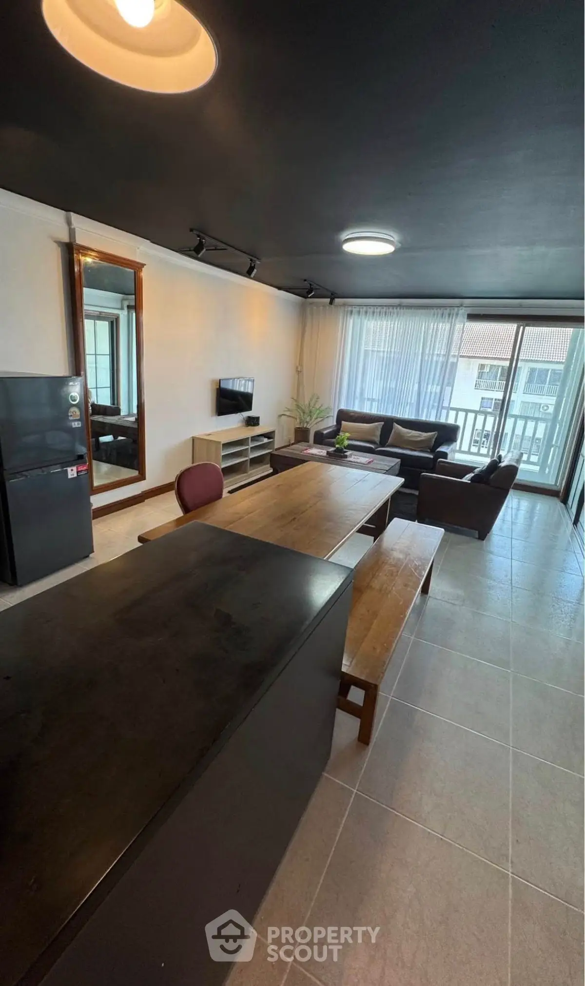 Spacious modern living room with stylish furniture and large windows