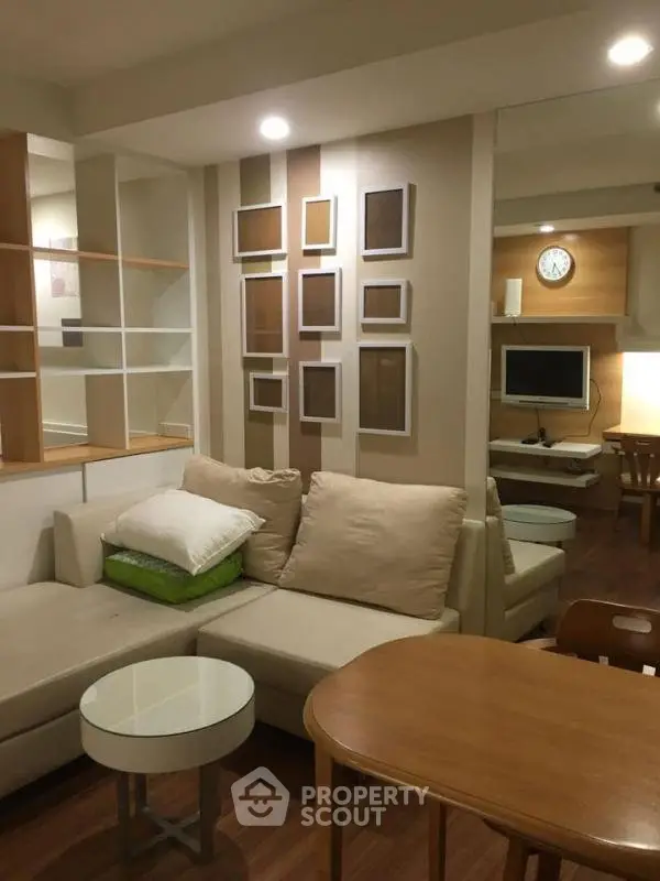 Cozy living room with modern decor and comfortable seating in a stylish apartment.