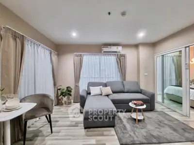 Modern living room with cozy gray sofa and elegant decor in a stylish apartment.