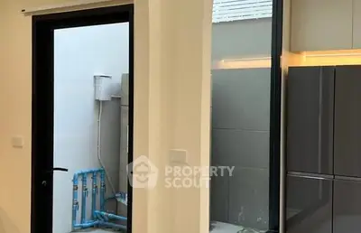 Modern kitchen with sleek cabinetry and large windows for natural light.