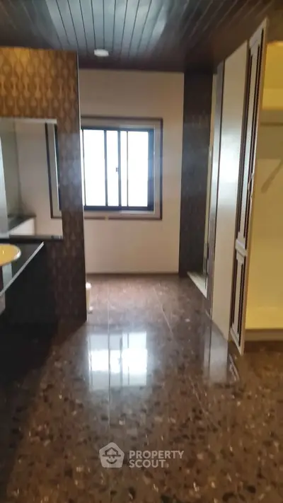 Spacious bathroom with elegant design and large window for natural light.