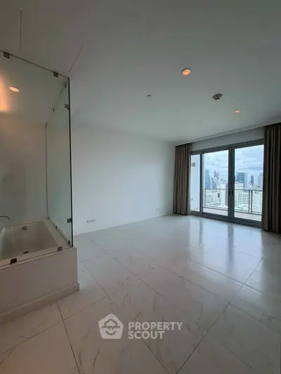 Spacious modern living room with city view and elegant marble flooring.