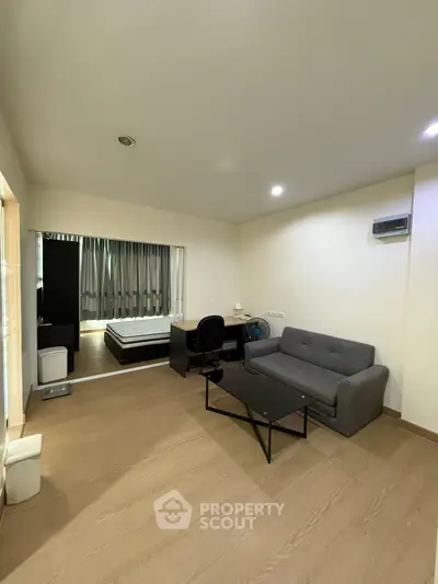 Spacious studio apartment with modern furnishings and wooden flooring
