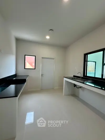 Modern kitchen with sleek countertops and ample natural light