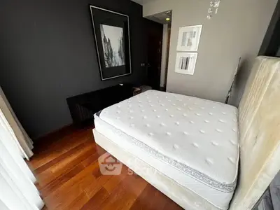 Modern bedroom with stylish decor and hardwood flooring