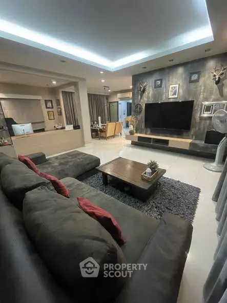 Spacious modern living room with stylish decor and large sectional sofa.