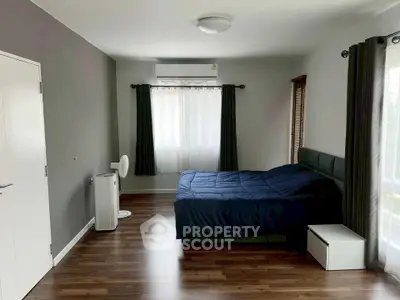 Spacious bedroom with modern decor and natural light