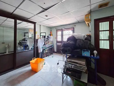 Spacious storage room with ample natural light and organized shelving, perfect for versatile use.