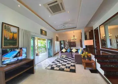 Spacious living room with modern decor and large balcony access