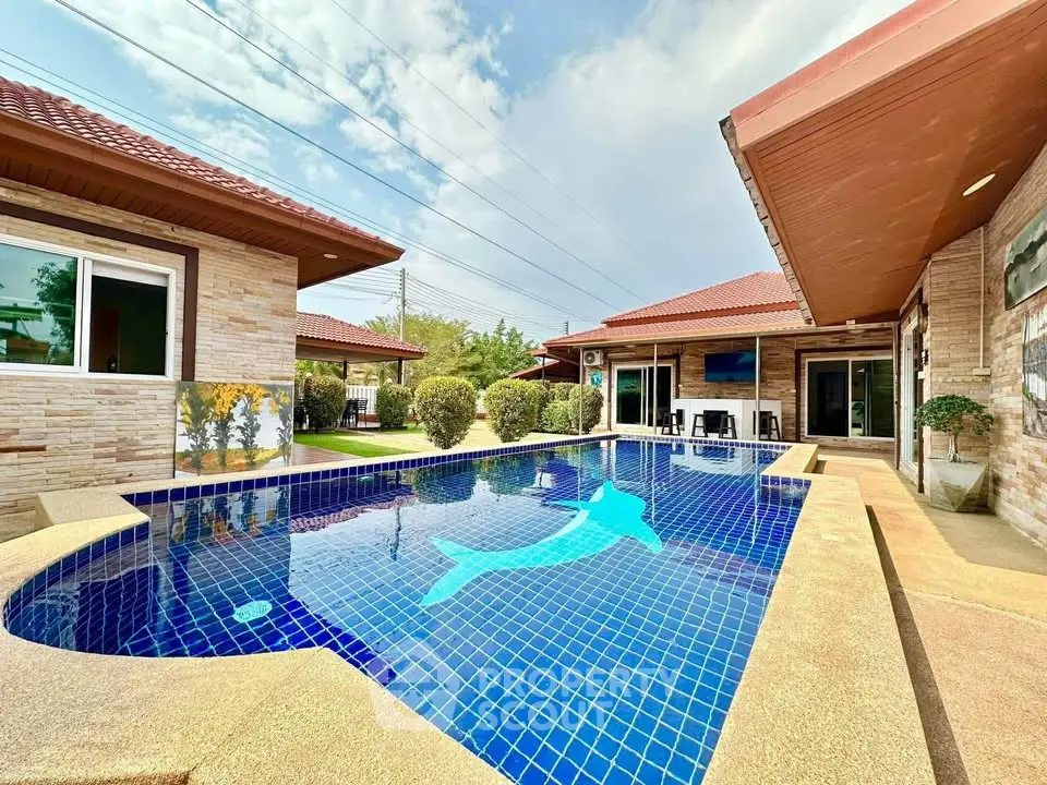 Luxurious villa with stunning pool and dolphin mosaic, perfect for relaxation and entertainment.