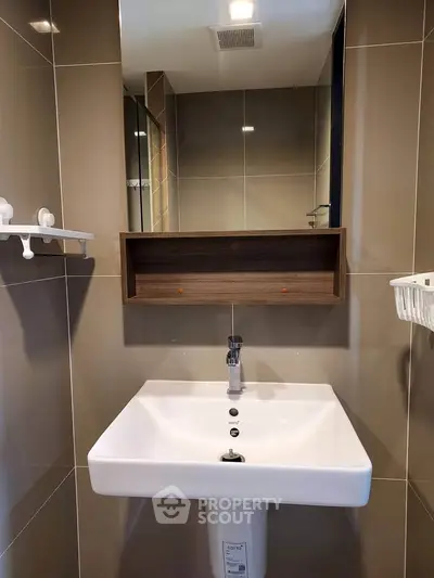Modern bathroom with sleek sink and mirror in stylish apartment
