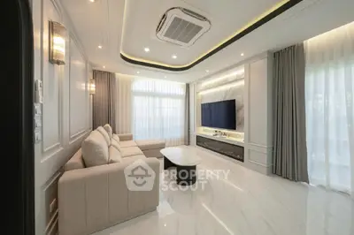 Luxurious modern living room with elegant sofa and large TV, featuring sleek design and ambient lighting.