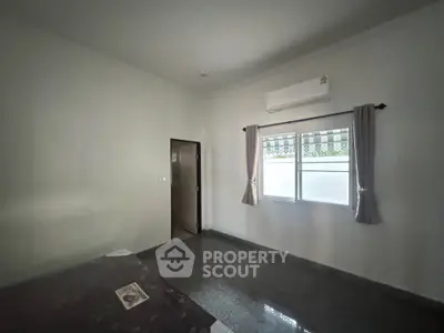 Spacious bedroom with air conditioning and natural light, perfect for comfort and relaxation.