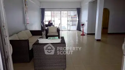 Spacious living room with modern furniture and natural light, perfect for family gatherings.