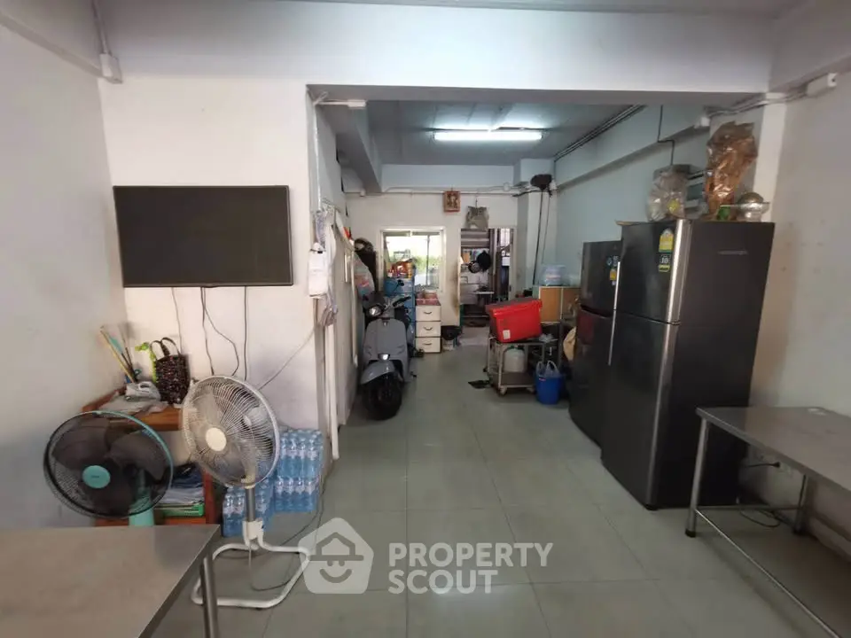 Spacious interior with refrigerator and scooter, ideal for versatile use.