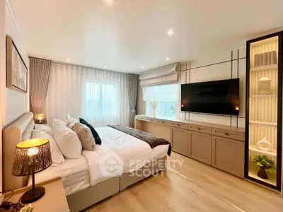 Luxurious bedroom with modern decor, large windows, and ambient lighting