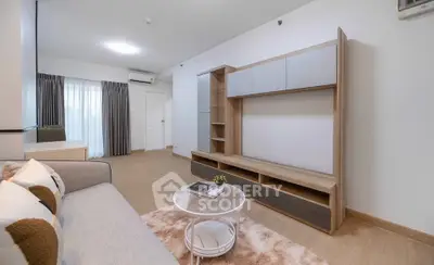 Modern living room with stylish furniture and natural light, perfect for relaxation and entertainment.