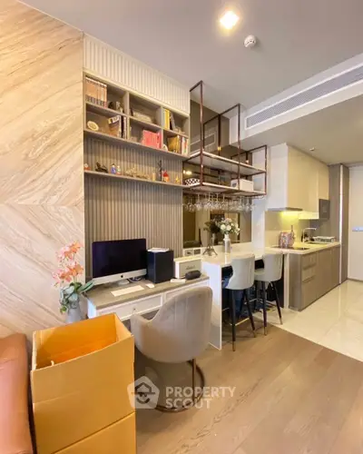 Modern open-layout kitchen and study area with sleek design and stylish shelving.