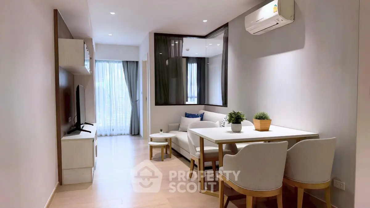 Modern living room with sleek furniture and natural light, perfect for relaxation and entertainment.
