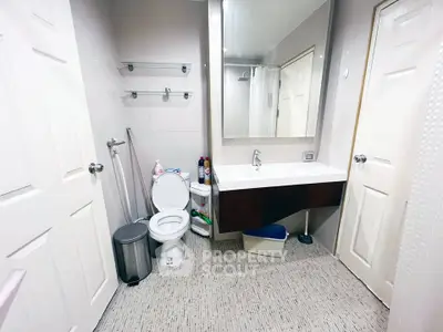 Modern bathroom with sleek vanity and large mirror in a contemporary home.