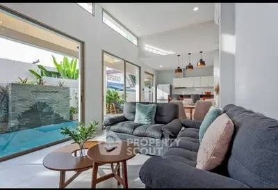 Modern living room with pool view and open kitchen layout