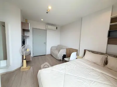 Modern bedroom with cozy bed, air conditioning, and stylish decor in a bright apartment.