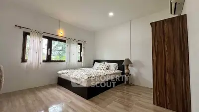 Cozy bedroom with wooden wardrobe and natural light