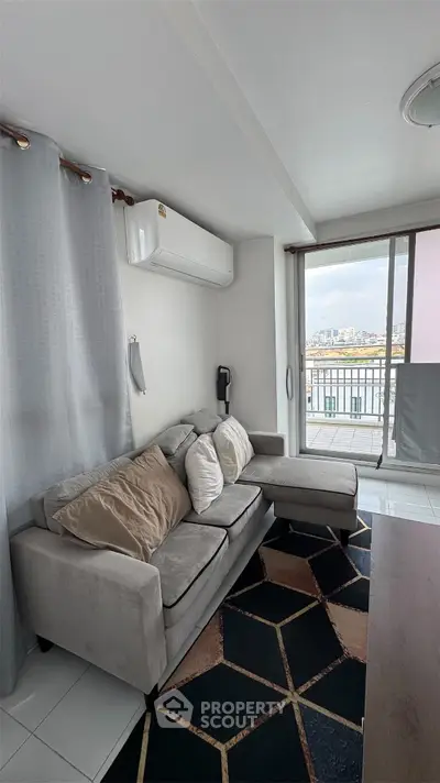 Modern living room with stylish sofa and balcony view in urban apartment