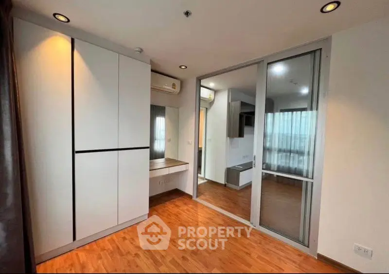 Modern apartment interior with wooden flooring and built-in wardrobe