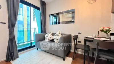 Modern living room with cozy sofa, dining area, and balcony view in stylish apartment.