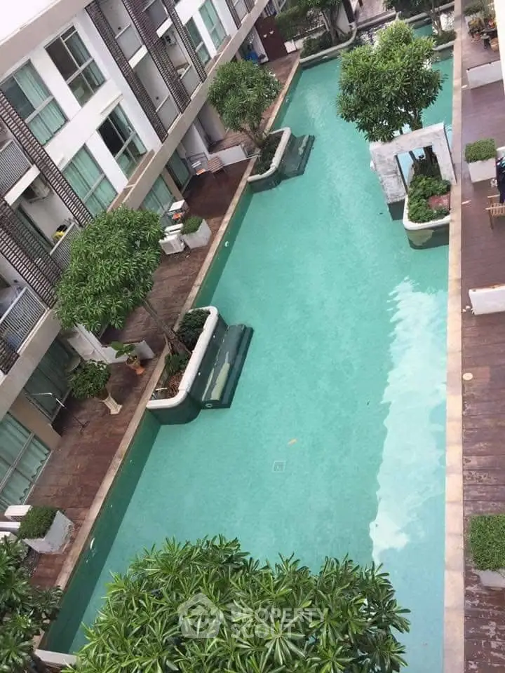 Luxurious residential pool with lush greenery and modern design